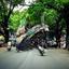 A group of motorcycle riders traveling down a shaded street..jpg